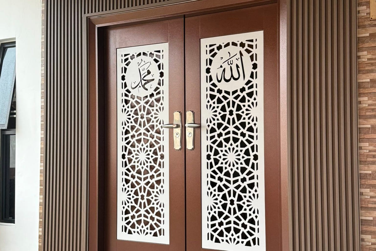A new house entrance: a pair of timber-finish doors with white laser-cut calligraphy panels, flanked by vertical fluted timber-look wall panelling.